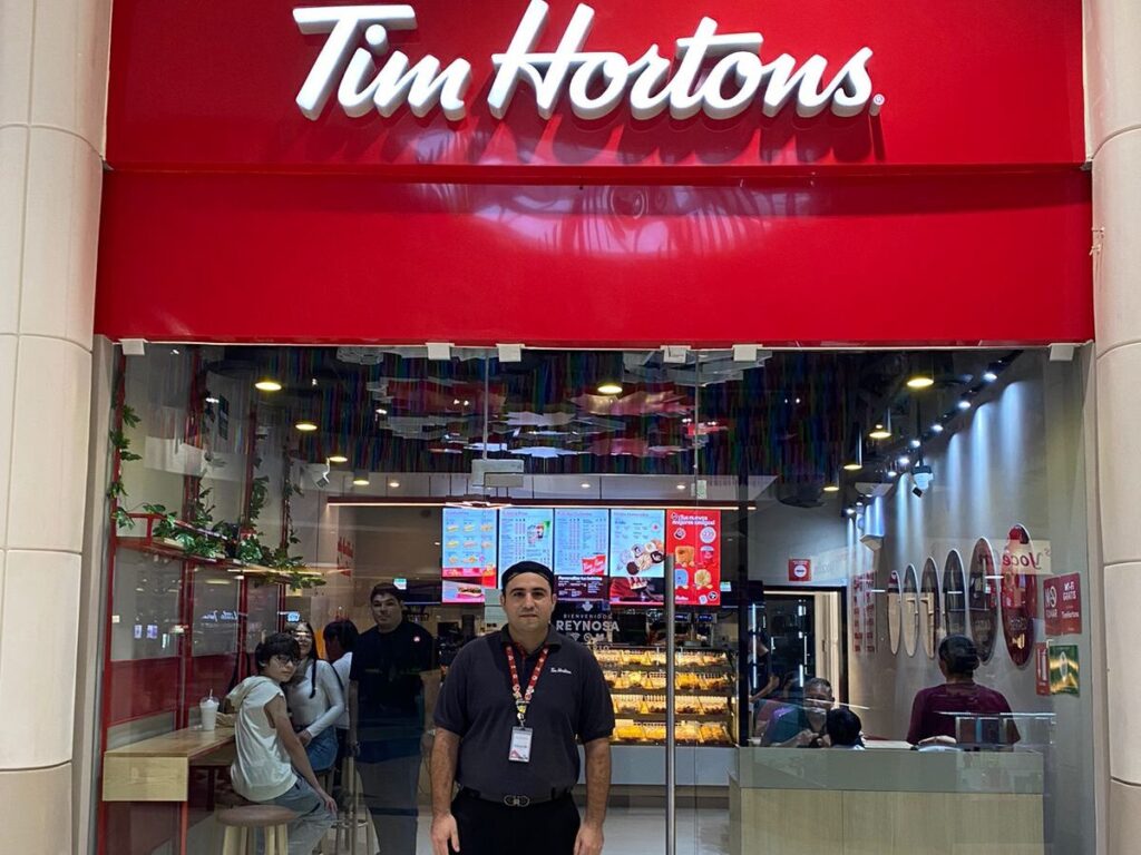Eduardo Villarreal, assistant manager, stands outside Tim Hortons in Reynosa, Tamaulipas.