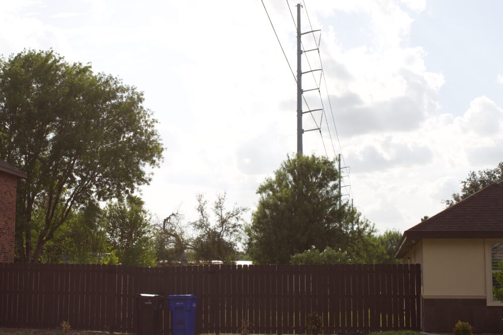 An electric line sits between two single family homes.
