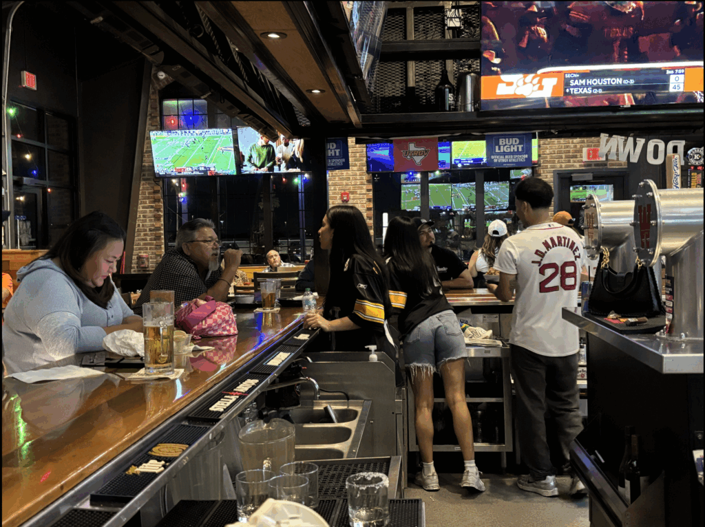 Fans watch UTRGV football against Texas Wesleyan University on TV screens at Walk-On’s Sports Bistreaux in Edinburg, Sept. 20, 2025.