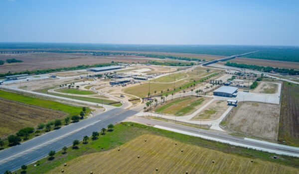 Aerial photo of the Anzalduas International Bridge cargo inspection area with roadways, inspection bays, and surrounding farmland.