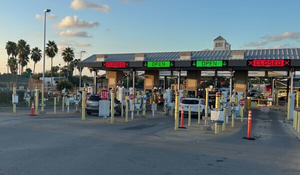 Cars wait at the Brownsville & Matamoros Bridge toll plaza between Texas and Mexico.