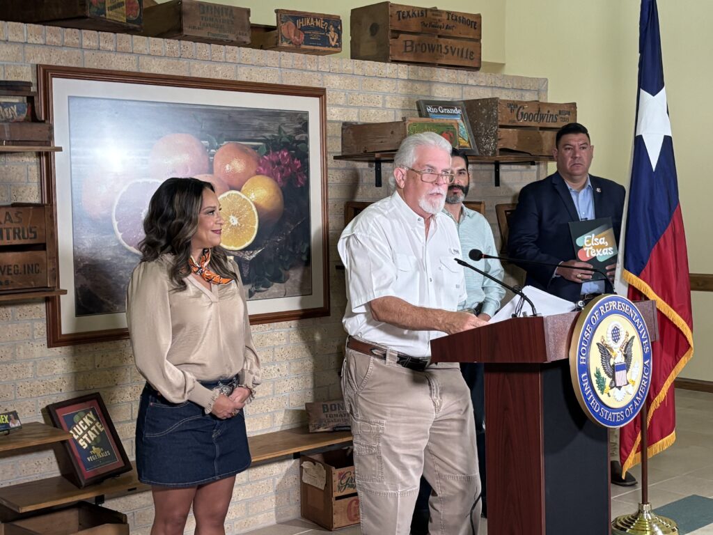 U.S. Rep. Monica De La Cruz stands beside Texas Citrus Mutual President Dale Murden as he speaks at a podium during a press conference in Mission, Texas, calling for Mexico to meet its water-delivery obligations to the United States under the 1944 treaty. Also pictured are Texas International Produce Association President and CEO Dante Galeazzi and Elsa Economic Development Corporation Executive Director Daniel Rivera.
