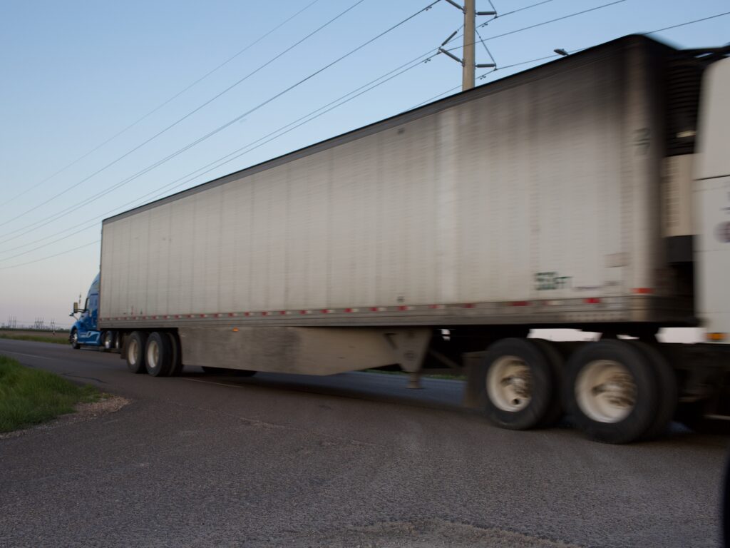 A blurry tractor trailer.