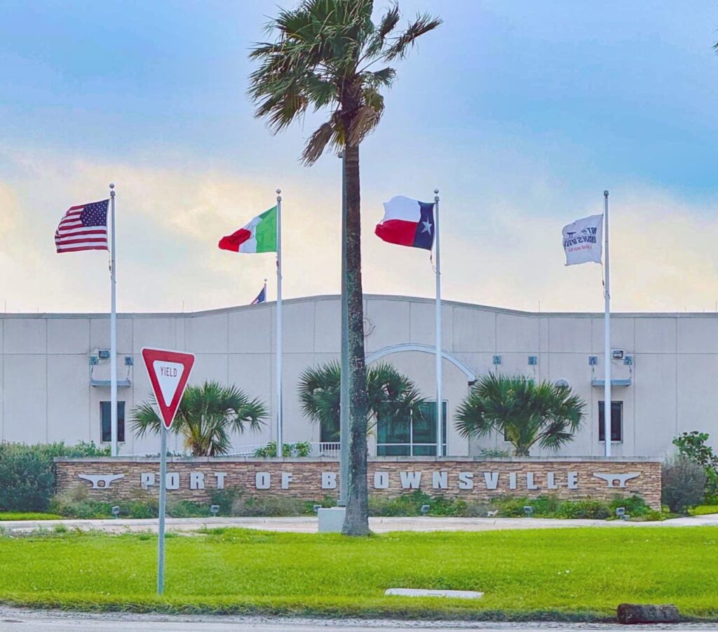 Port of Brownsville headquarters with U.S., Mexico, Texas, and port flags flying.