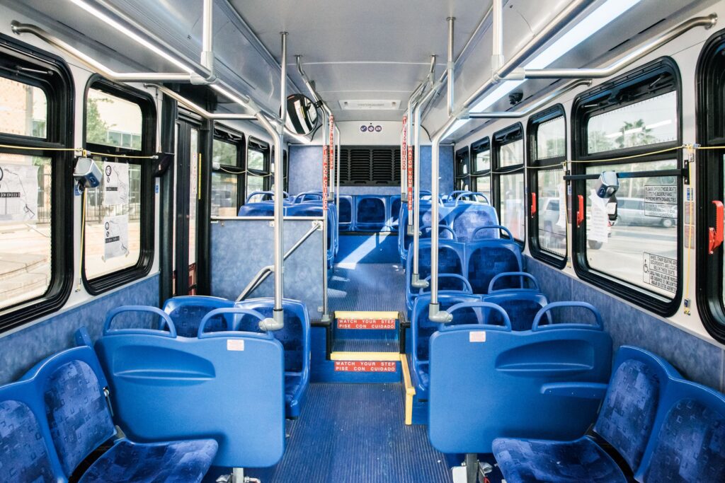 Interior view of Brownsville Metro bus with blue seats and handrails.
