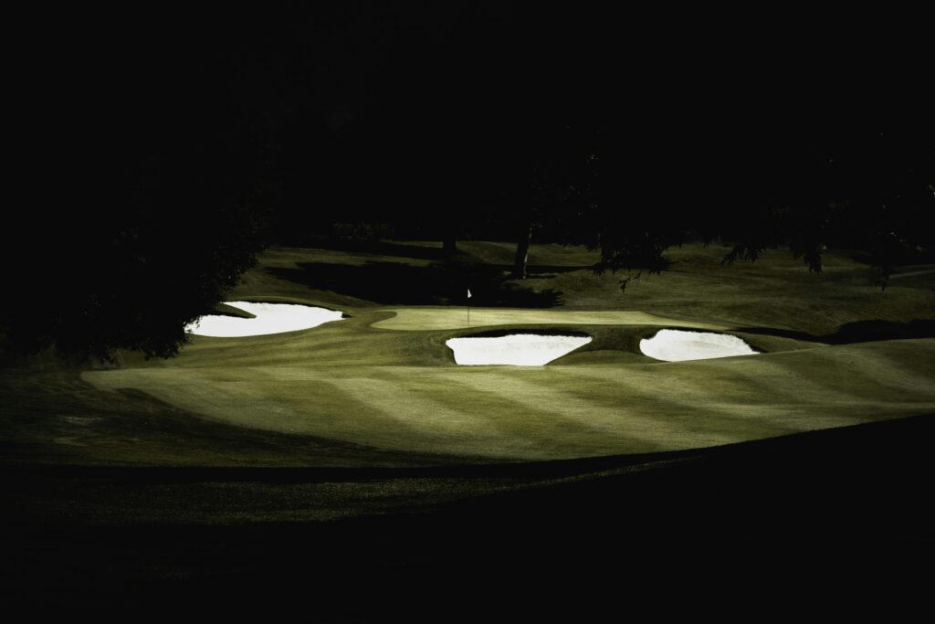 Golf course fairway and sand bunkers lit at night, illustrating Mission’s plan for a lighted course