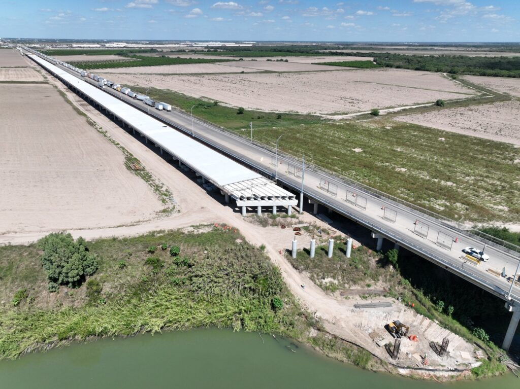 Aerial view showing construction work on the new four-lane span being built parallel to the existing Pharr International Bridge over the Rio Grande.