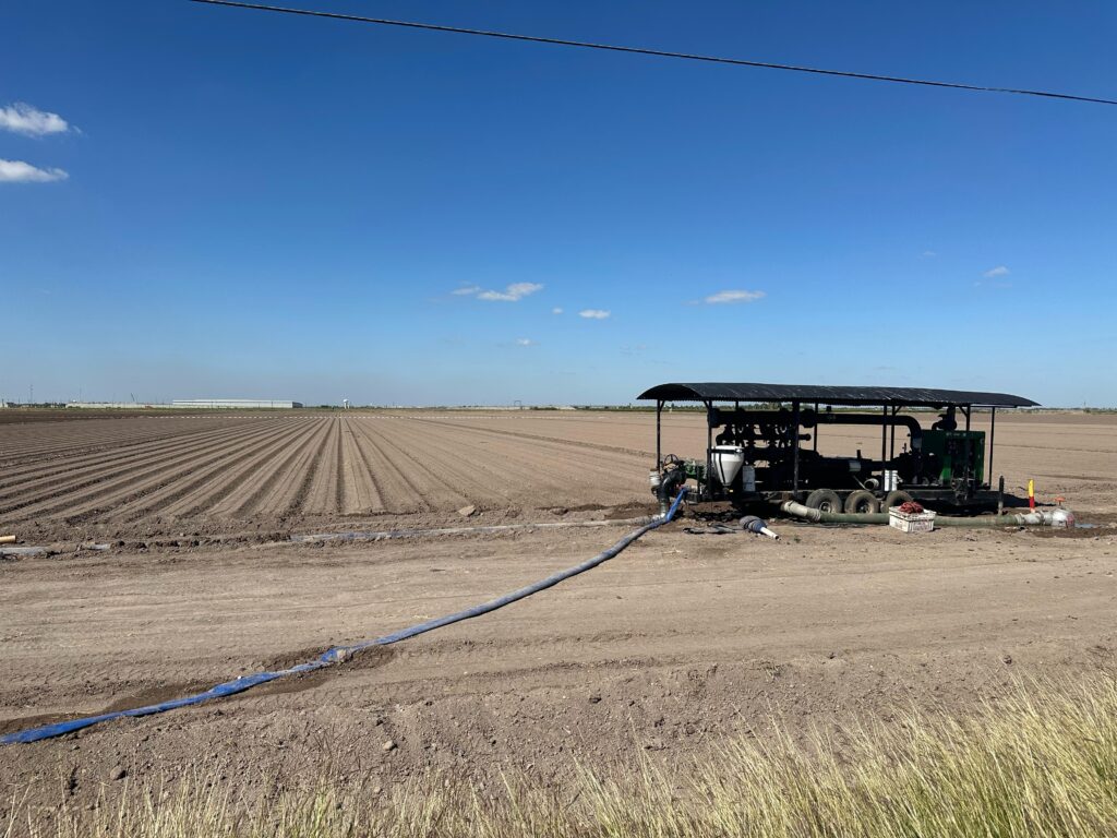 Irrigation pump system connected to water lines along freshly plowed farmland in Hidalgo County, Texas.