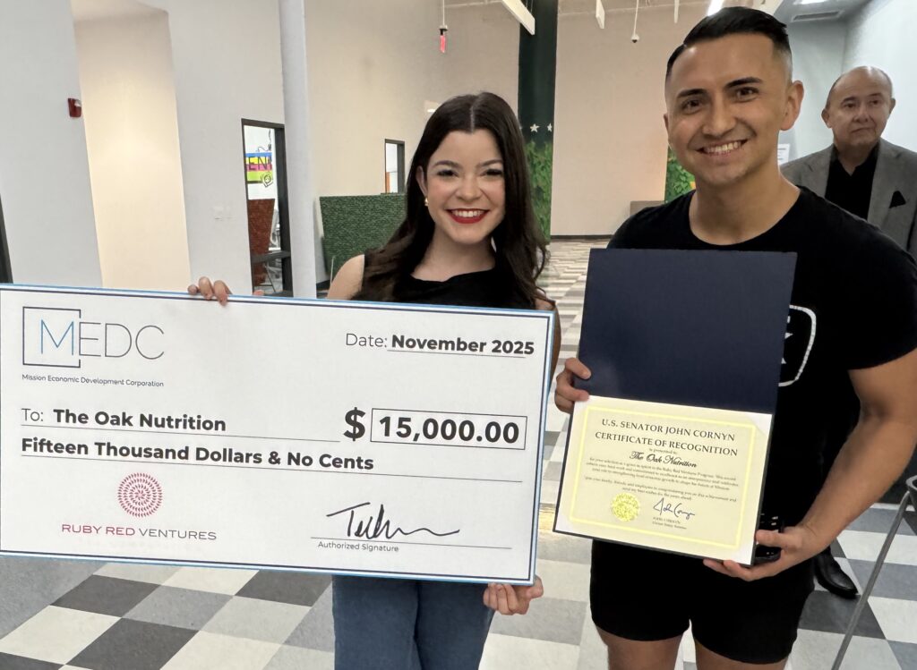 Two owners of The Oak Nutrition stand together after receiving a Ruby Red Ventures grant for repairs and upgrades.