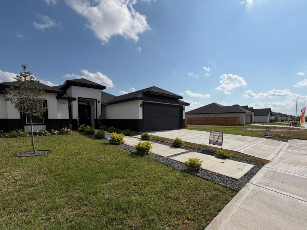 A single family home with a yard and sky.