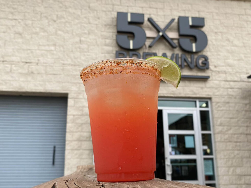 A michelada-style beer in front of the 5x5 Brewing Com