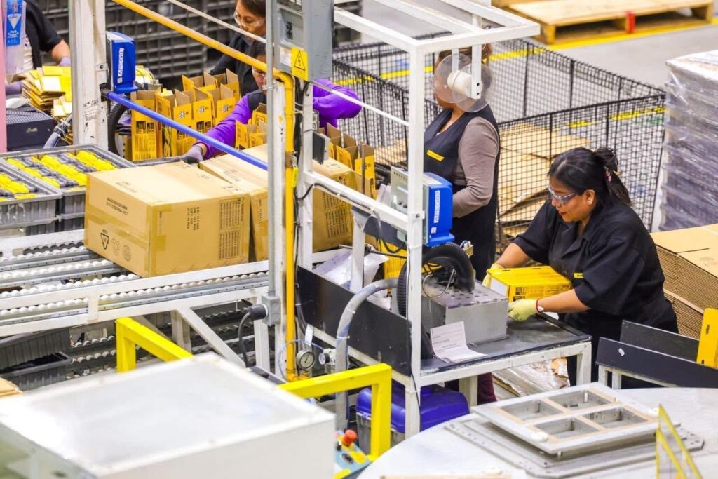 Workers assemble electronics components on a production line inside a manufacturing facility in Reynosa, Tamaulipas.