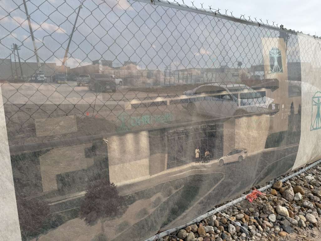 Construction rendering displayed on a fence at the future site of DHR’s behavioral health hospital in Pharr.