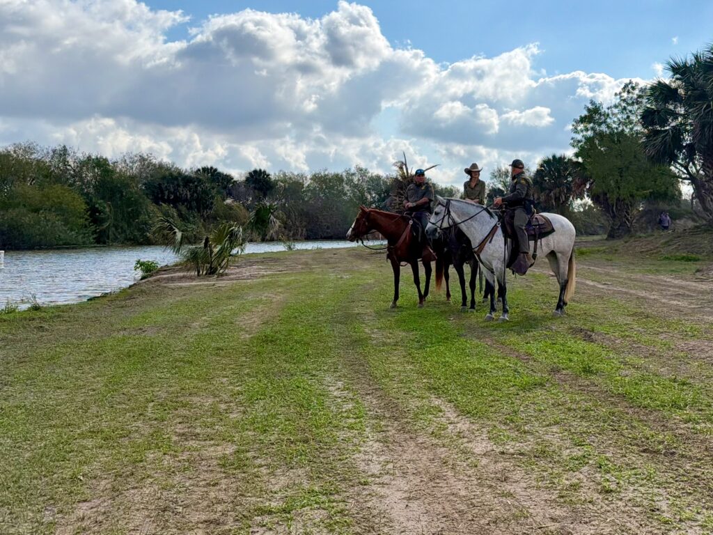 Mounted U.S. Border Patrol agents ride along the Rio Grande near a ranch in Brownsville during a border security operation.