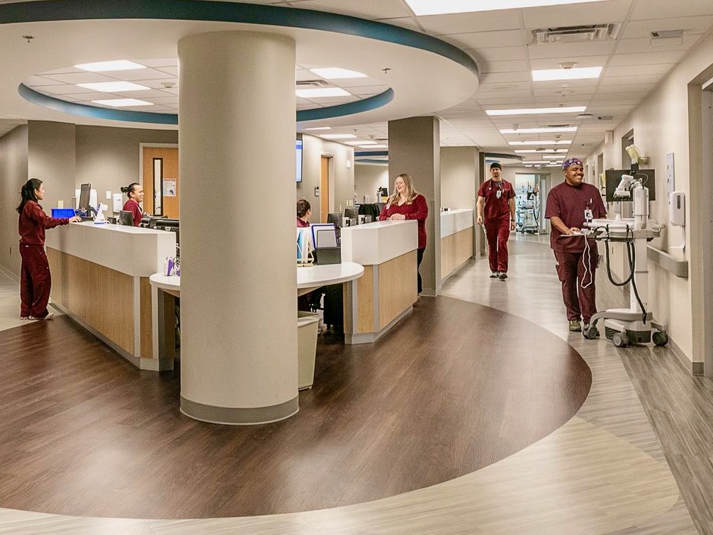 Staff members walk through a central nurses’ station inside South Texas Health System McAllen’s brain care unit.