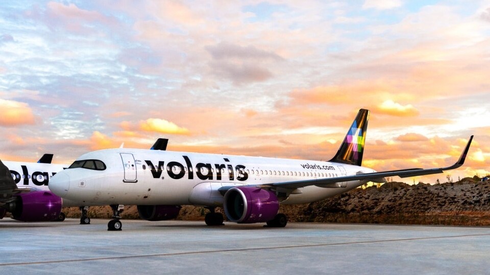 Volaris passenger aircraft parked on an airport runway with company branding visible on the fuselage.