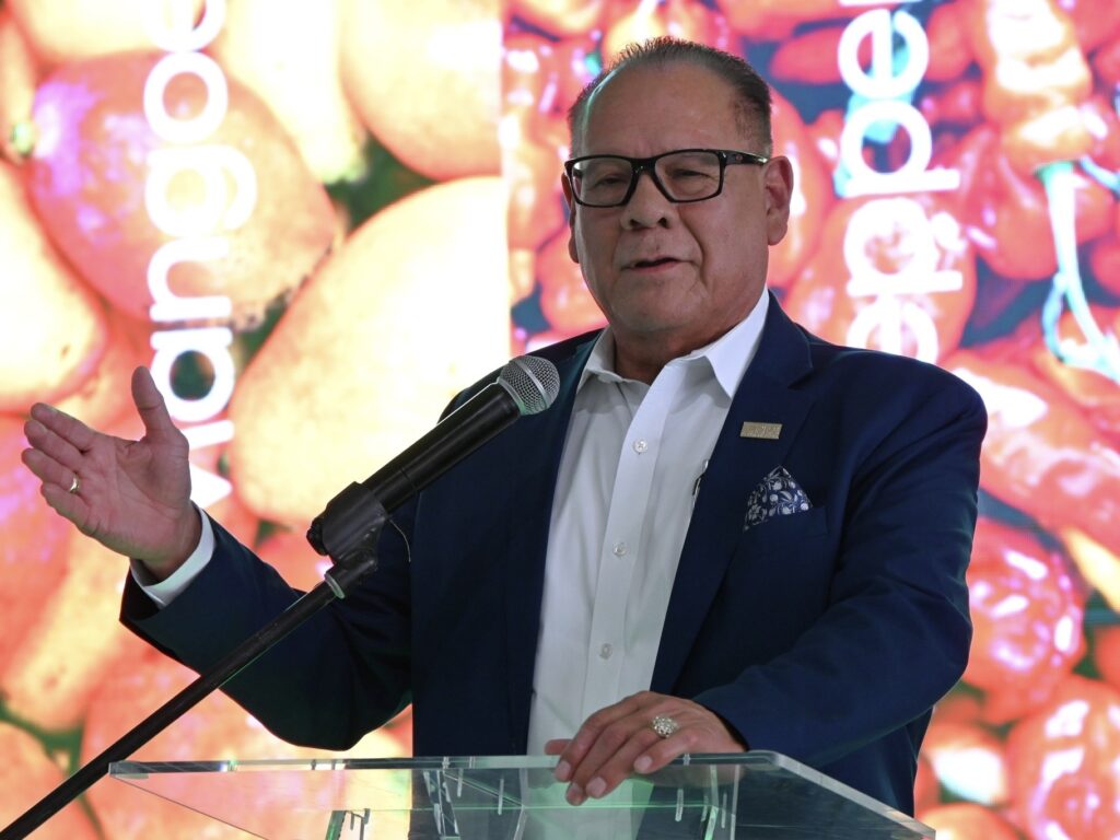 Victor Perez speaks into a microphone at the CIL Fresh Pharr ribbon-cutting event.