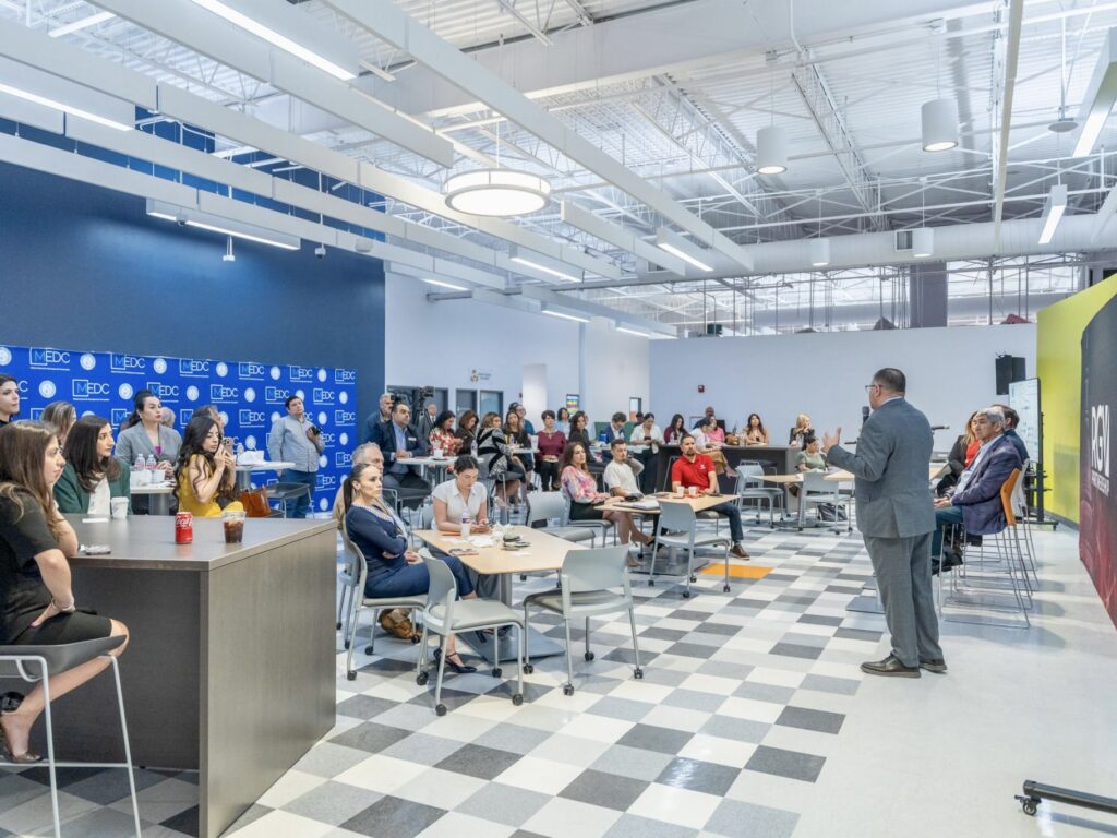Attendees sit at tables inside a modern conference space during the RGV Connect transportation forum hosted by the RGV Partnership.