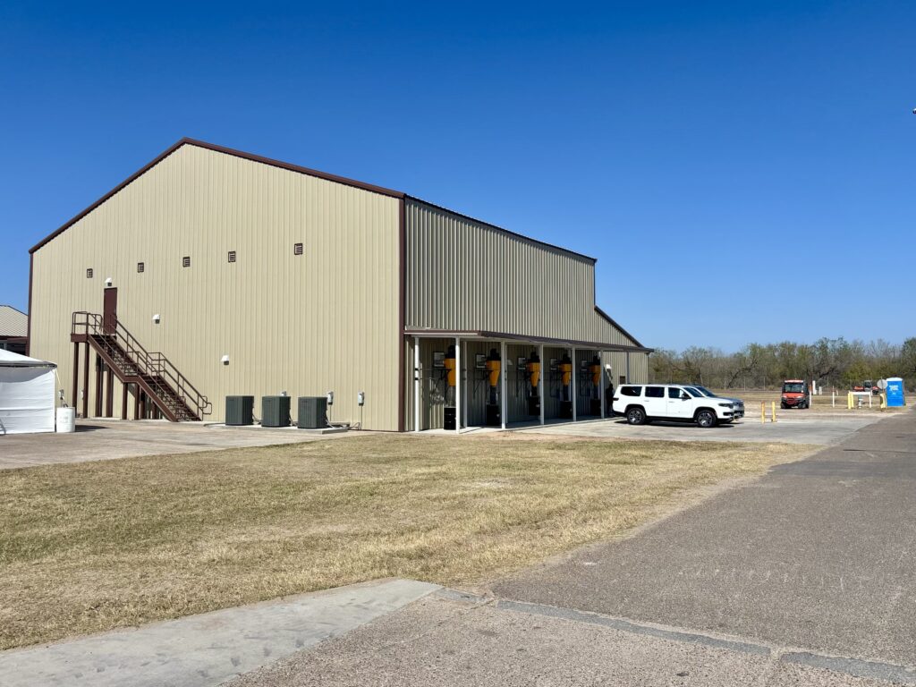 Exterior view of a large metal building at Moore Air Field that houses USDA operations for dispersing sterile screwworm flies.