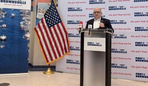 Port of Brownsville CEO William Dietrich speaks at a podium during a briefing about the proposed refinery project at the port.