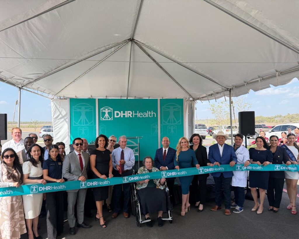 Community leaders hold a ribbon during a ceremony marking the expansion of a DHR Health medical campus in Rio Grande City.