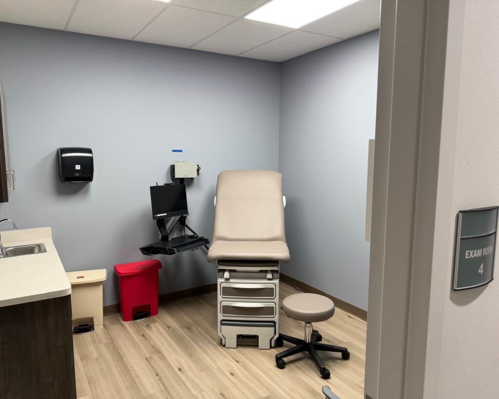 An empty exam room with a medical table and diagnostic equipment inside a DHR Health clinic in Rio Grande City.