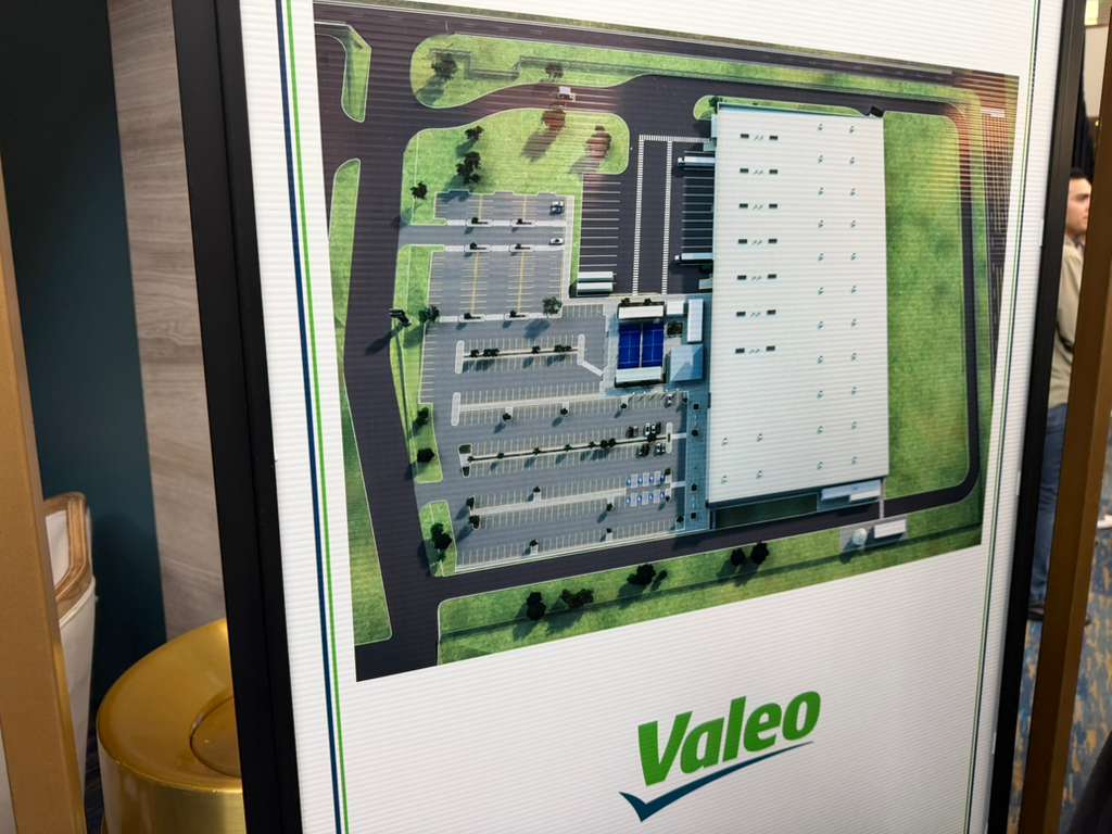 Representación impresa del plano de situación que muestra la distribución de unas instalaciones industriales proyectadas, con aparcamiento y vías de acceso.