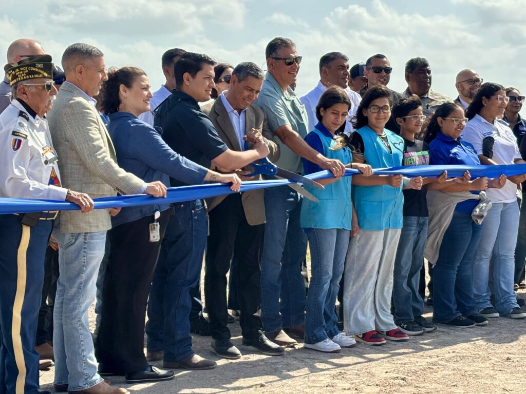 Officials and residents participate in a ribbon-cutting ceremony for a Hidalgo County drainage infrastructure project.