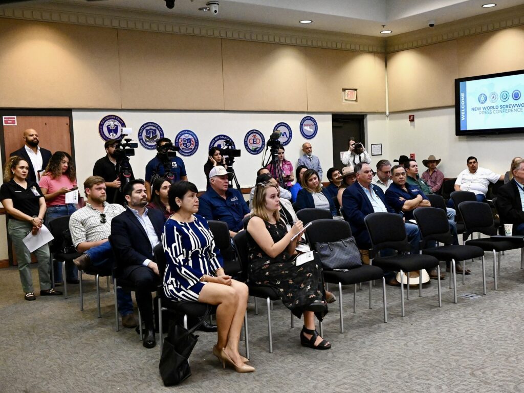 Audience members and media crews attend a New World screwworm press conference in Weslaco, Texas.