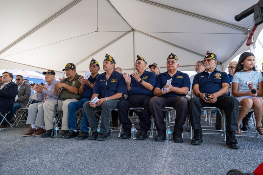 Veterans seated under a tent during the VFW Post 2410 groundbreaking event.