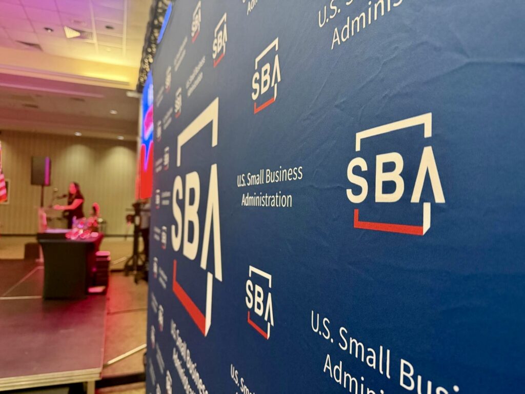 Close-up of a U.S. Small Business Administration backdrop during a National Small Business Week event in Weslaco.