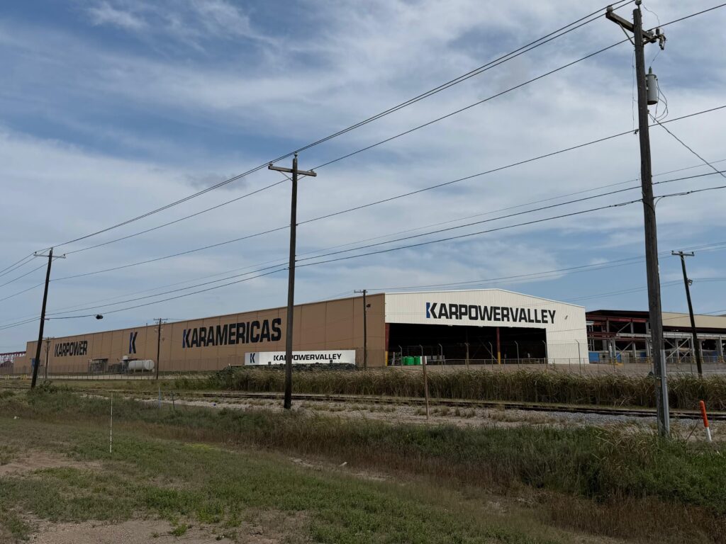 Industrial shipyard buildings branded with Karpower Valley signage at the Port of Brownsville.