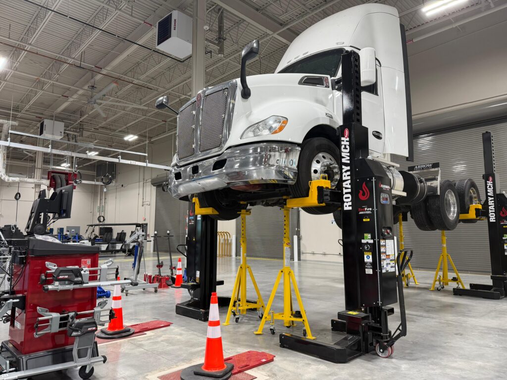 Heavy-duty diesel truck suspended on a vehicle lift inside Texas State Technical College’s Transportation Technology Center in Harlingen, where students train for transportation and diesel technology careers.