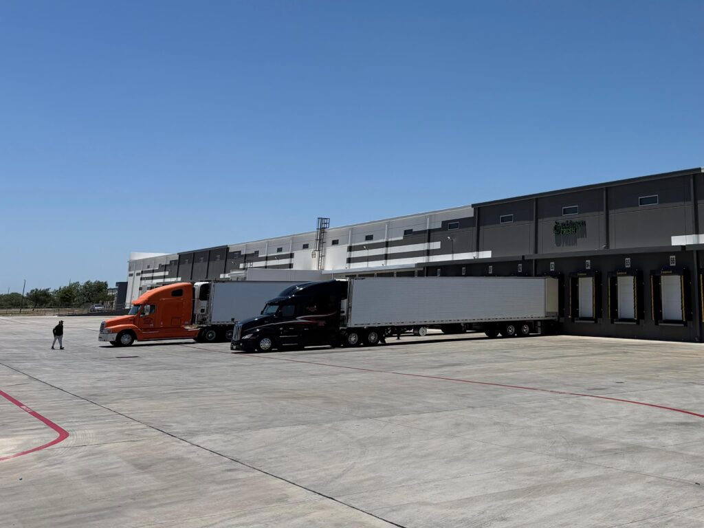 Tractor-trailers are parked at loading docks outside the Robinson Fresh cold storage facility in Pharr, Texas.