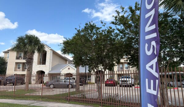 Apartment complex in Edinburg with a leasing banner displayed outside, representing rental housing options in the Rio Grande Valley.