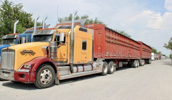 Commercial trucks are parked along a roadway near the Las Flores cargo crossing on the Mexican side of the Progreso International Bridge in Nuevo Progreso, Tamaulipas, during a truckers’ protest that disrupted cargo operations and agricultural shipments between Mexico and Texas.