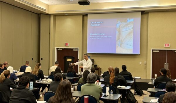 Physician instructing a classroom of medical residents during a South Texas Health System training session