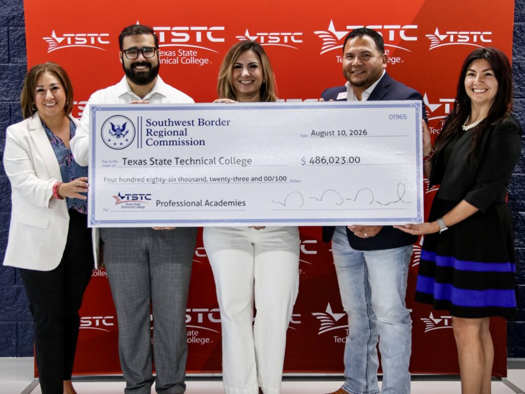 Texas State Technical College and Southwest Border Regional Commission representatives hold a ceremonial $486,023 grant check for commercial driver training in Harlingen.