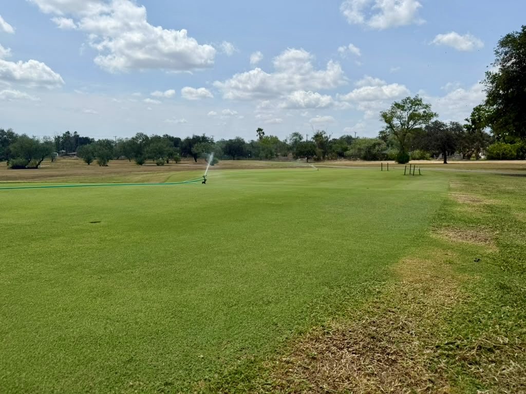 A sprinkler waters a green at Ebony Hills Golf Course in Edinburg.