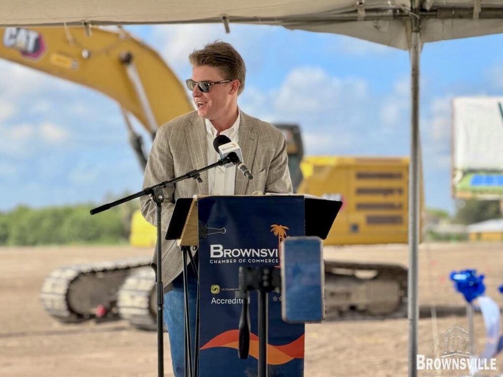 Nick Rhodes speaks at a podium during the Villas Las Lagunas groundbreaking in Brownsville.
