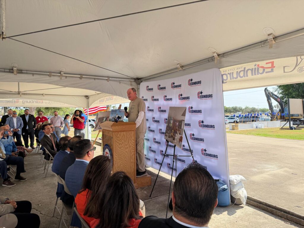 Bill Carlson speaks at a podium during the Ebony Hills Golf Course groundbreaking in Edinburg.