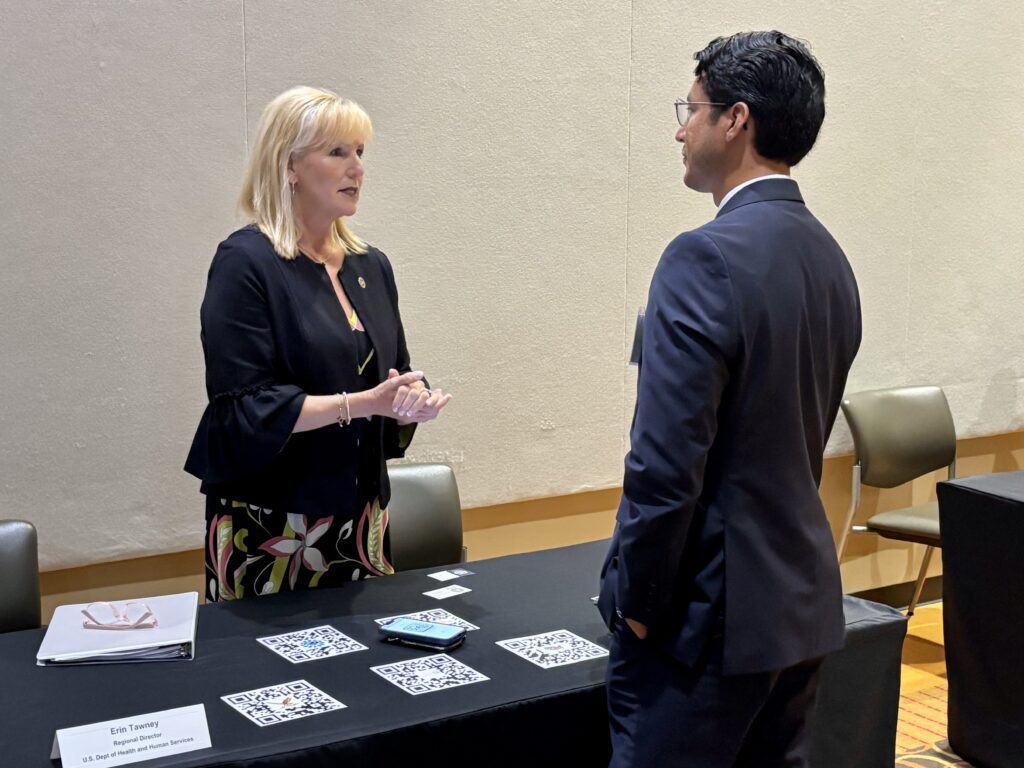 A federal representative speaks with an attendee during a USDA Rural Development forum in Edinburg.