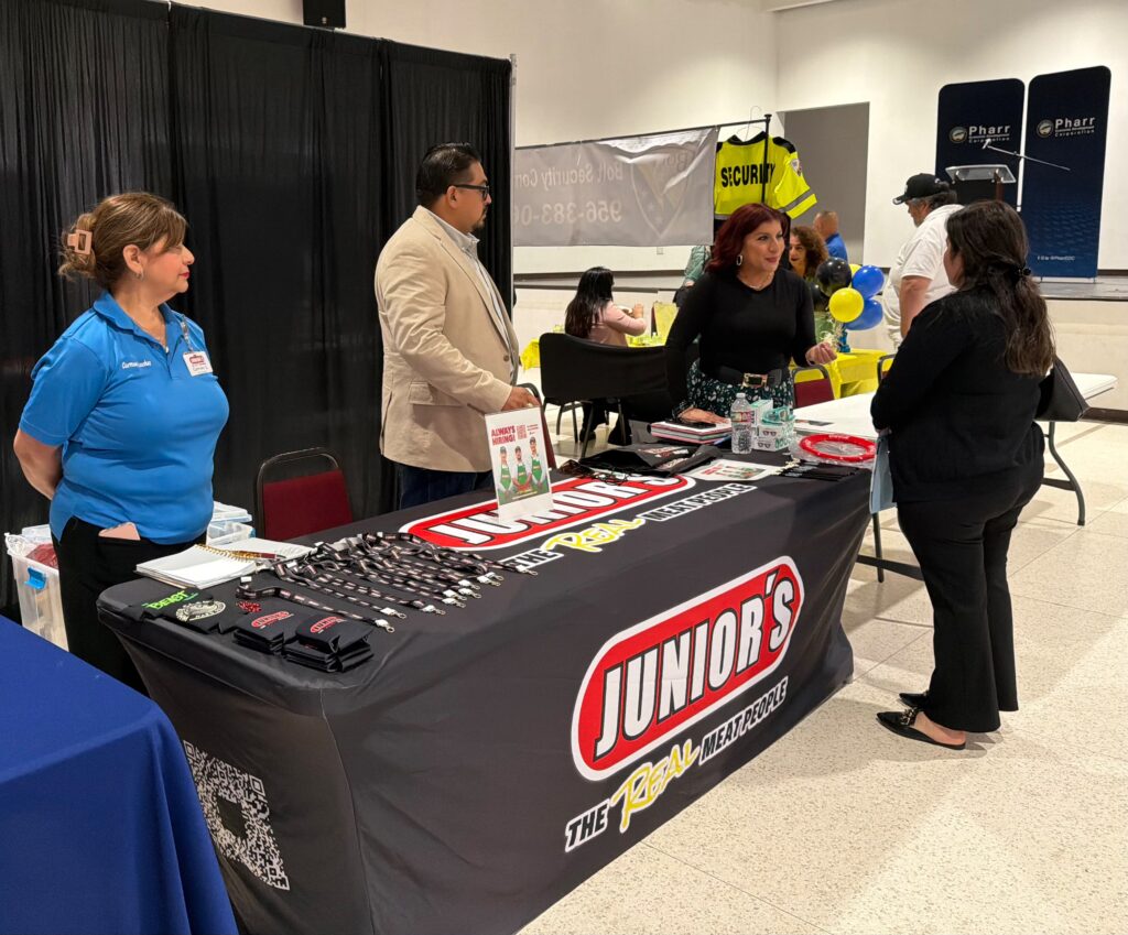 Elizabeth Chavez of Junior’s Supermarket speaks with a job seeker during a Workforce Solutions job fair in Pharr.