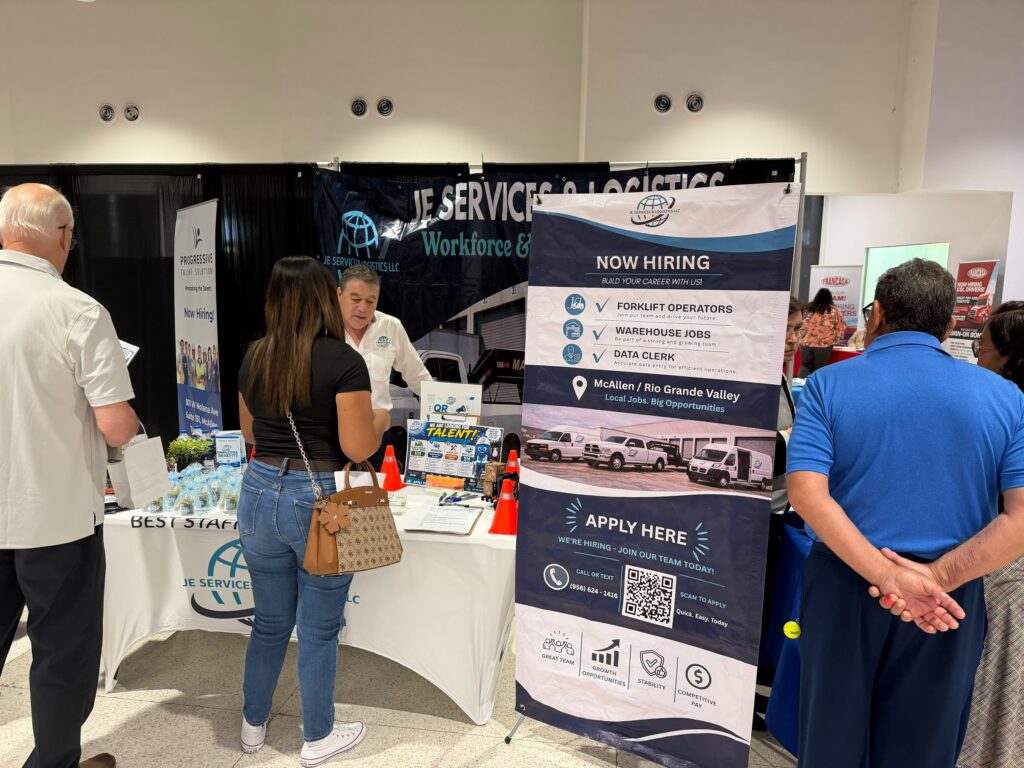 Job seekers visit a logistics company hiring booth during a Workforce Solutions job fair in Pharr, Texas.