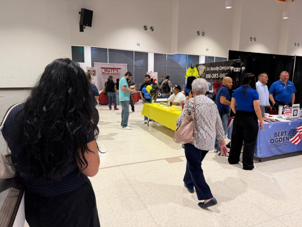 Job seekers visit employer booths during a Workforce Solutions job fair in Pharr, Texas.