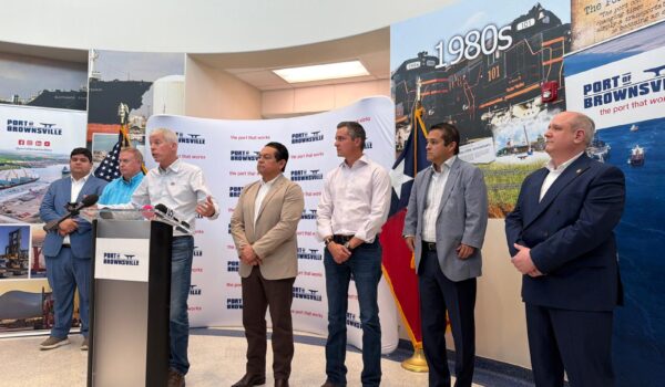 U.S. Energy Secretary Chris Wright speaks at a podium during a news conference at the Port of Brownsville, joined by local and state officials during a visit highlighting energy and industrial development projects at the port.