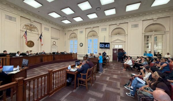 A wide view of the Brownsville City Commission chambers shows residents attending a public hearing on proposed zoning changes related to data centers.