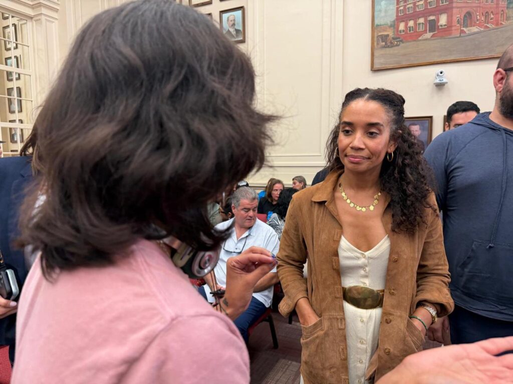 SpaceX executive Sheila McCorkle speaks with a protester inside Brownsville City Hall during a special City Commission meeting.