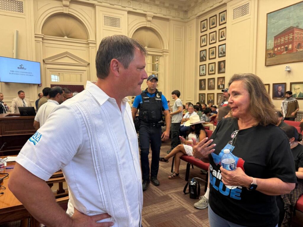 Rosemary Martinez speaks with Brownsville Public Utilities Board member Joseph Hollmann inside Brownsville City Hall following a special City Commission meeting.