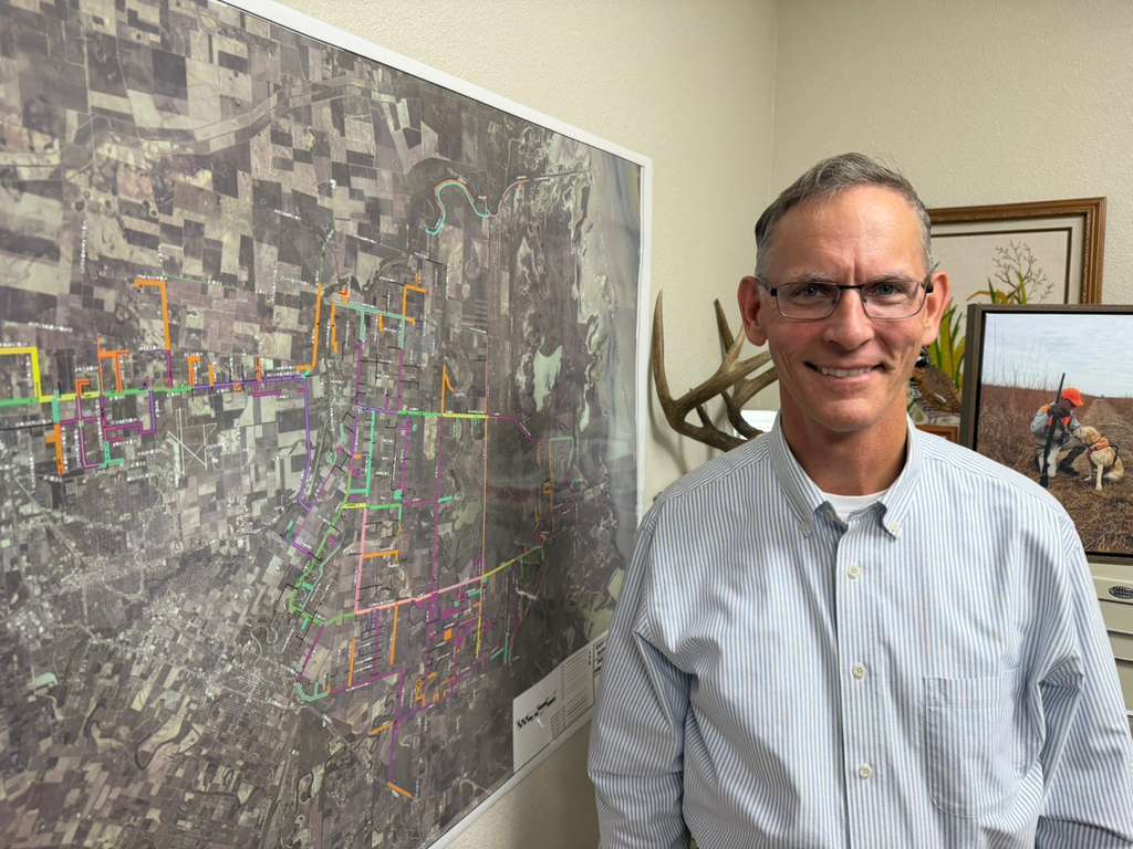 East Rio Hondo Water Supply Corporation General Manager Brian Macmanus stands beside a map of the utility’s service area.